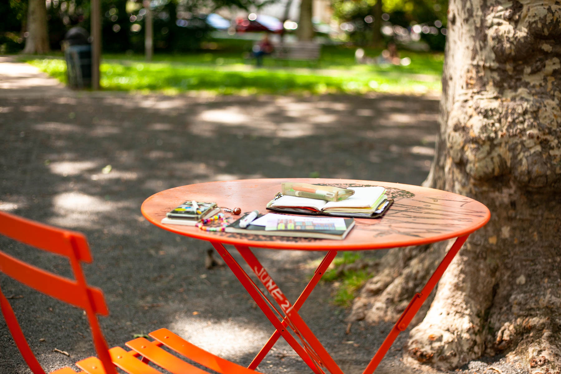 One of Clark Park's orange tables, where I come to sit and write