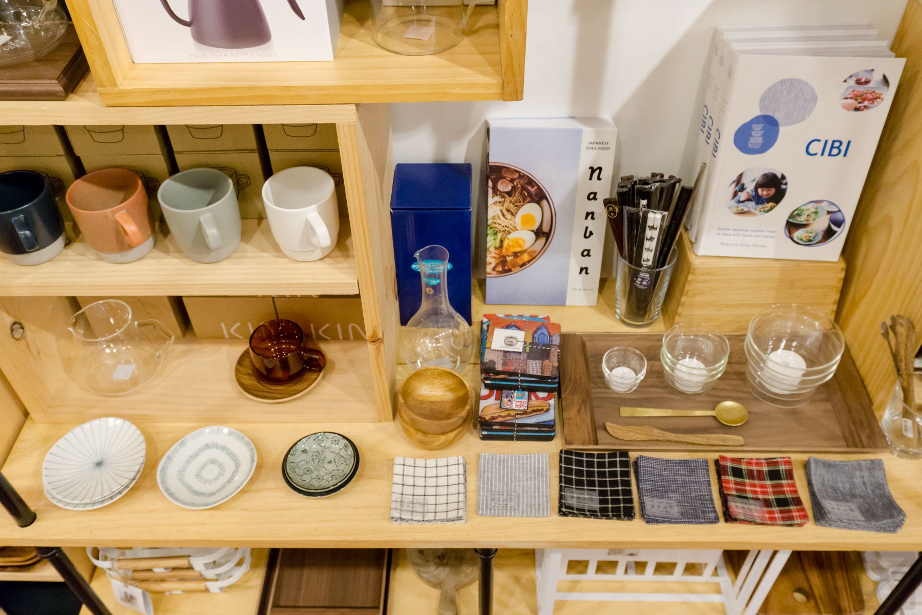An overhead peek at coffee mugs, coasters, and other table settings for a nice time