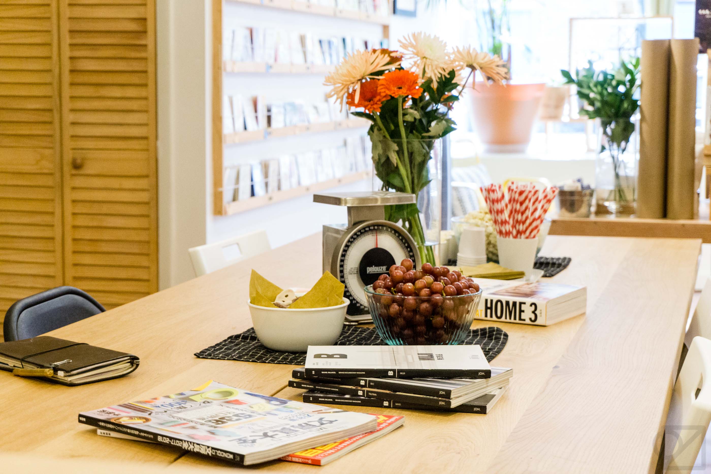 The meeting table set up with snacks and stationery related books for browsing