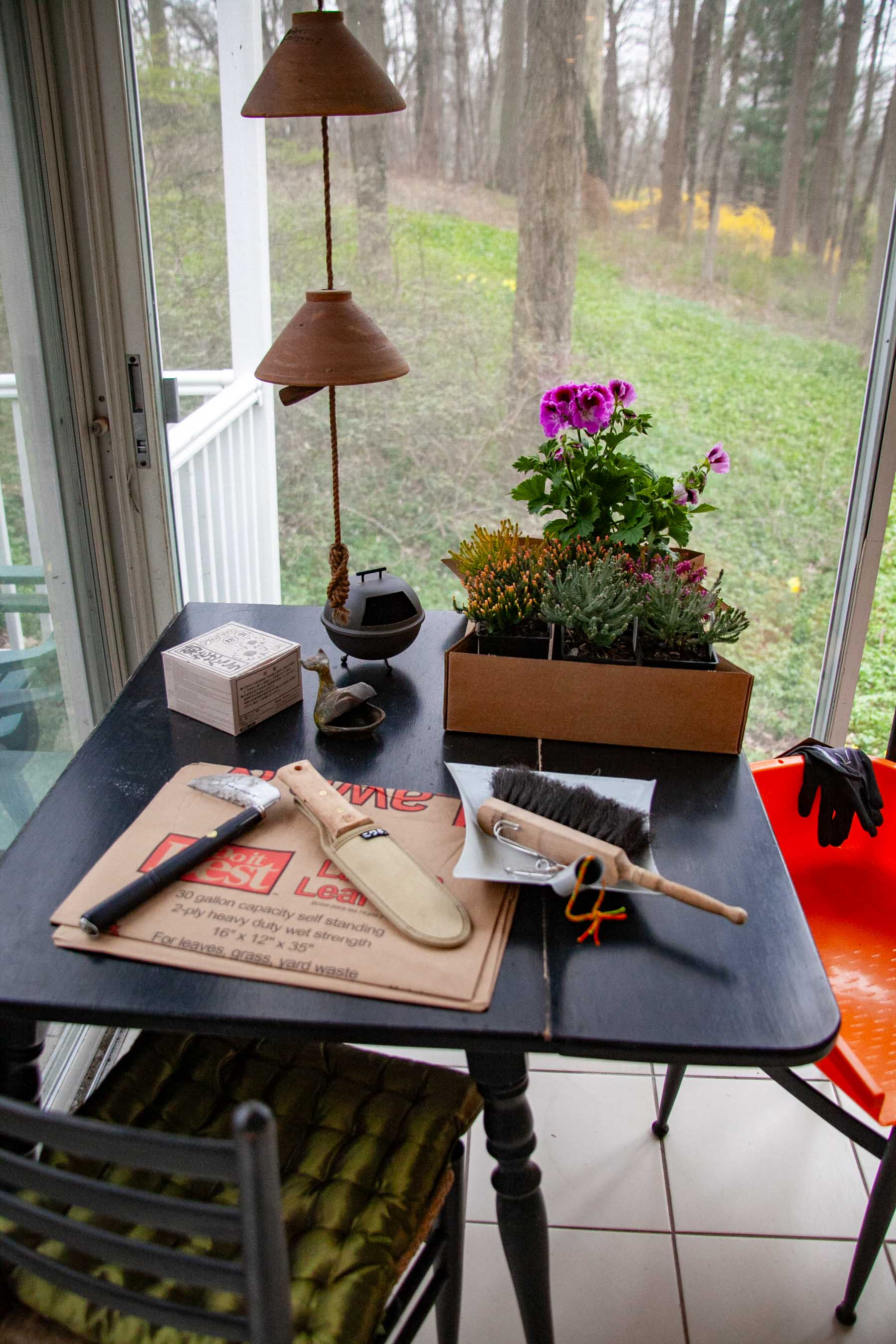 Supplies for early spring gardening set out on the porch table.