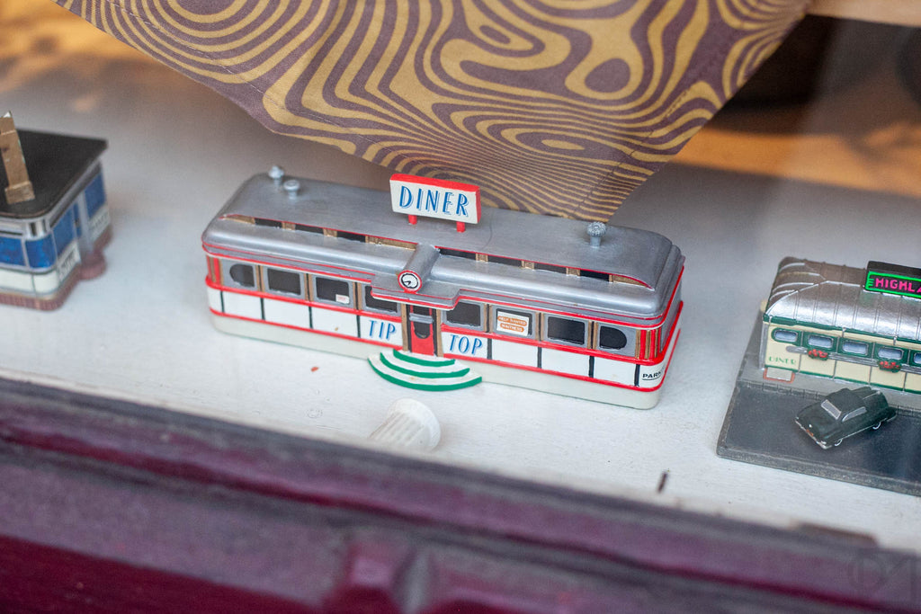 A miniature railcar diner from the collection of Liz's mother. The entry sign says TIP TOP