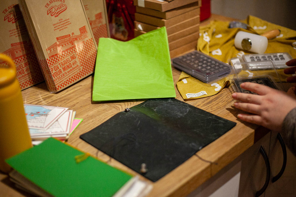 An Omoi staff alum experiments with some leather stamping tools in the back of the shop