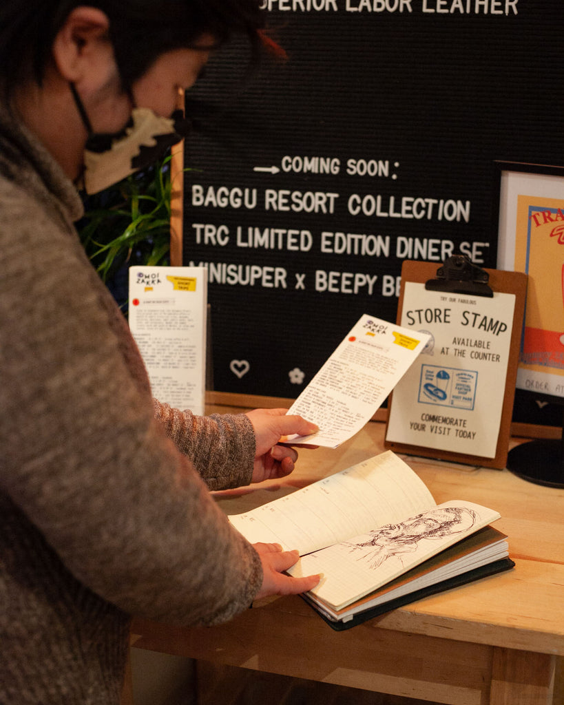 A visitor pauses at the DINER station to add items to their journal