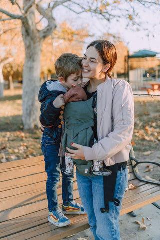 Woman using a baby carrier safely