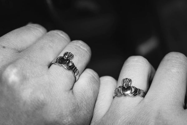 Two Hands Wearing Claddagh Rings