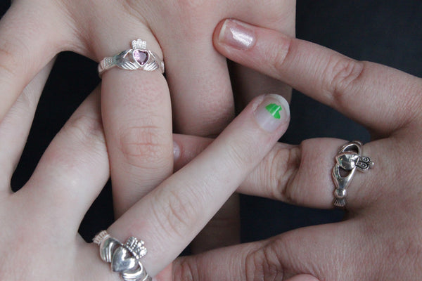 Three Hands Wearing Claddagh Rings