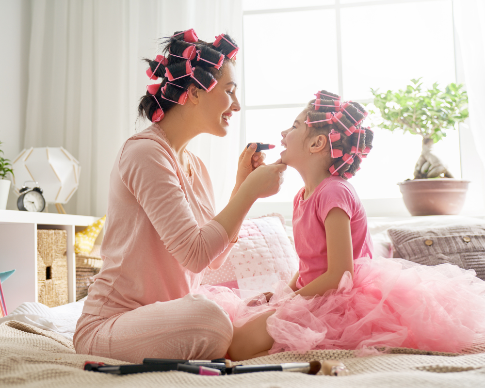 The Sophisticated mom with daughter putting on makeup