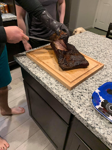 Final check of smoked brisket before carving