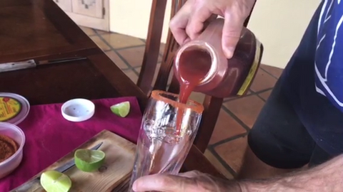 Pouring Tank's Bloody Mary Mix into a beer glass