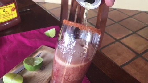 Pouring beer into a glass with Tank's Bloody Mary Mix