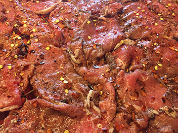 Beef strips marinated and prepared for the oven