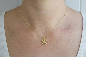 Model wearing AW Boutique gold filled jewellery. All Seeing Eye or Eye of Providence pendant charm on a dainty fine 16 inch cable necklace chain. Part of the Protection collection.