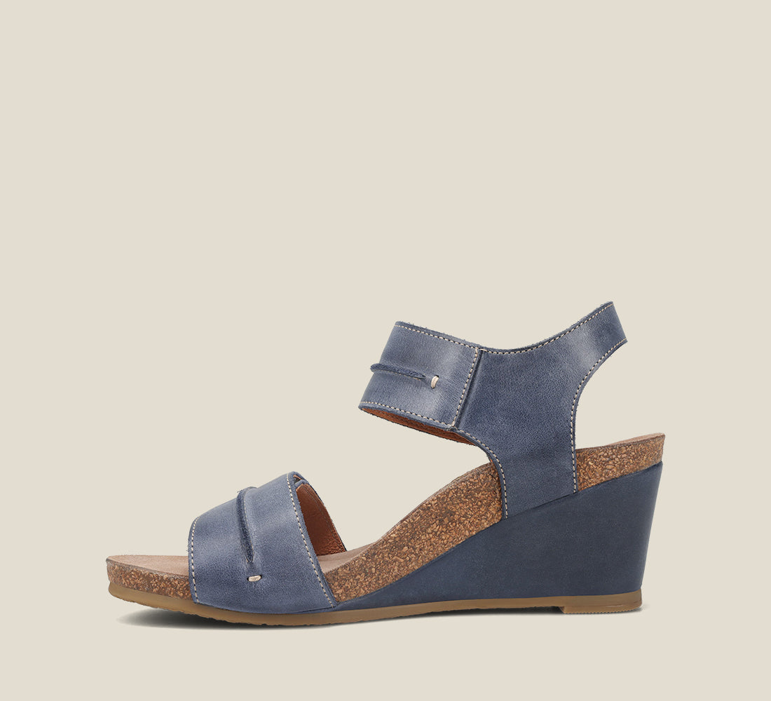 side Angle of Reason Dark Blue leather wedge featuring exceptional arch & metatarsal support with a rubber outsole