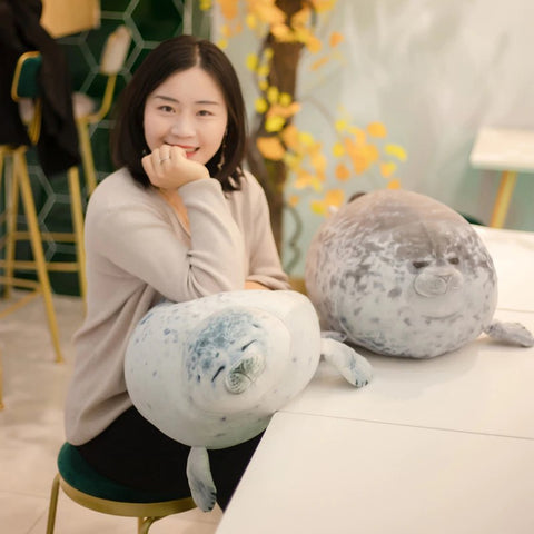 two real seal plushie pillows with girl