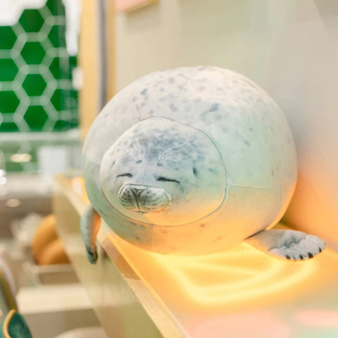 white seal plush pillow sitting around