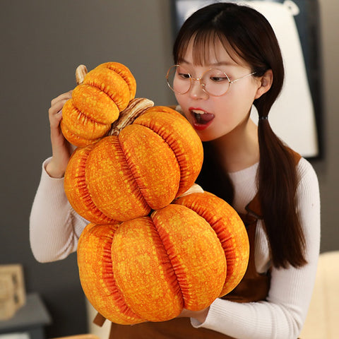 girl taking bite out of pumpkin pillow