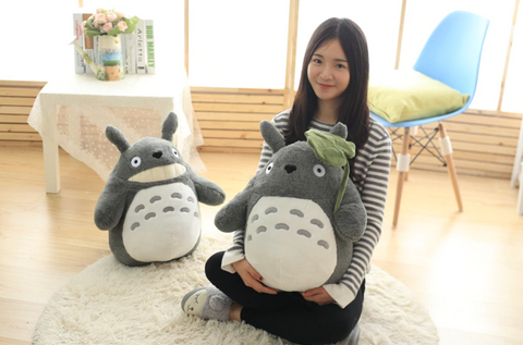 holding huge totoro plushie