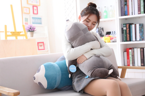 squeezing and hugging sleepy sloth plush