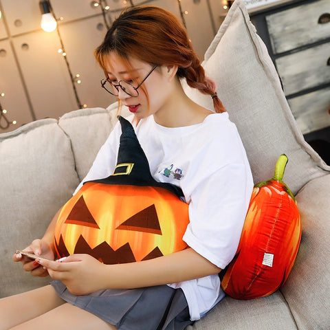 girl sitting on pumpkin plush pillow