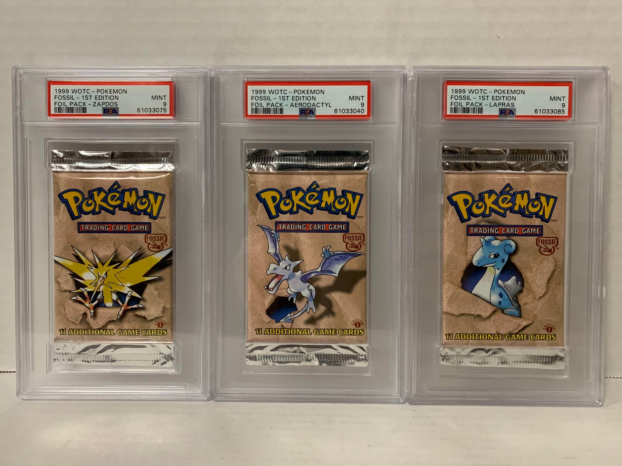 PSA 9 POKEMON FOSSIL FIRST EDITION BOOSTER PACK SET AERODACTYL LAPRAS –  Cards and Comics Central