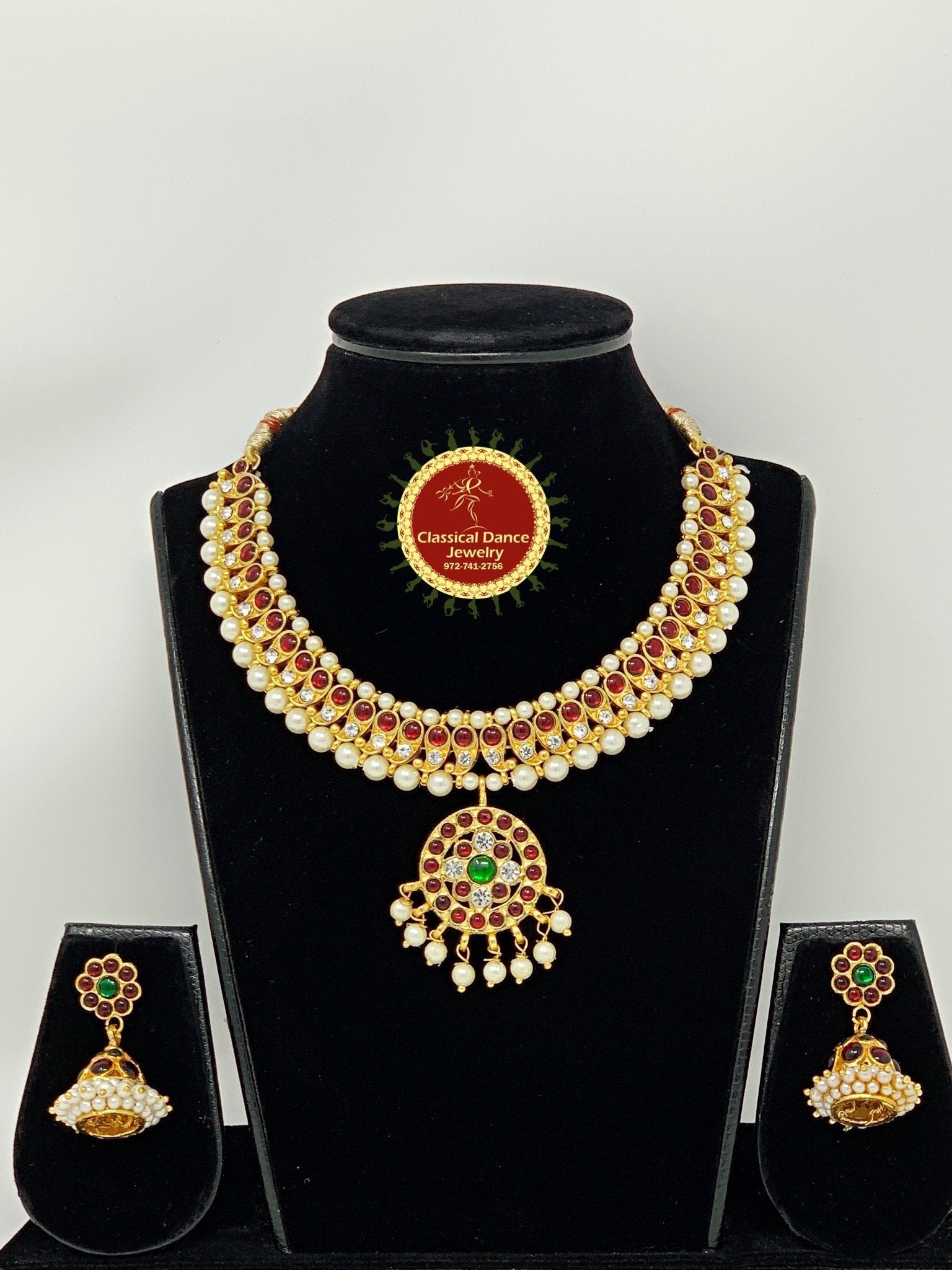 gold necklace with white stone designs