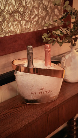 Two bottles of Wild Idol Alcohol Free Sparkling Wine chilling in an ice box at the 20 Berkeley Wild Idol event