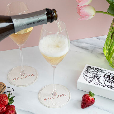 Flowers and Wild Idol's non alcoholic sparkling rose on a table