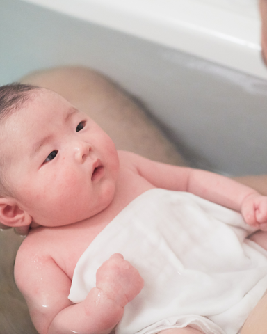 baby in bath with cloth on them