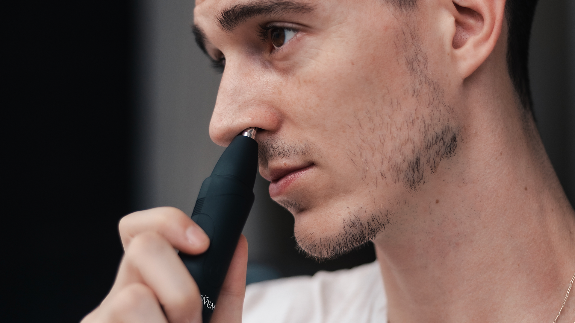 electric nose trimmer in hand