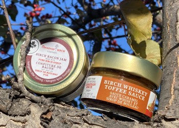 Birch Whiskey Toffee Sauce and Birch Bacon Jam in a tree on a sunny day