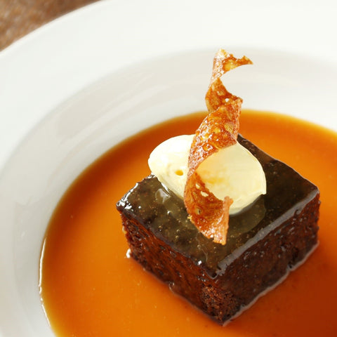 photo of a brownie with Birch Whiskey Toffee Sauce and vanilla ice cream