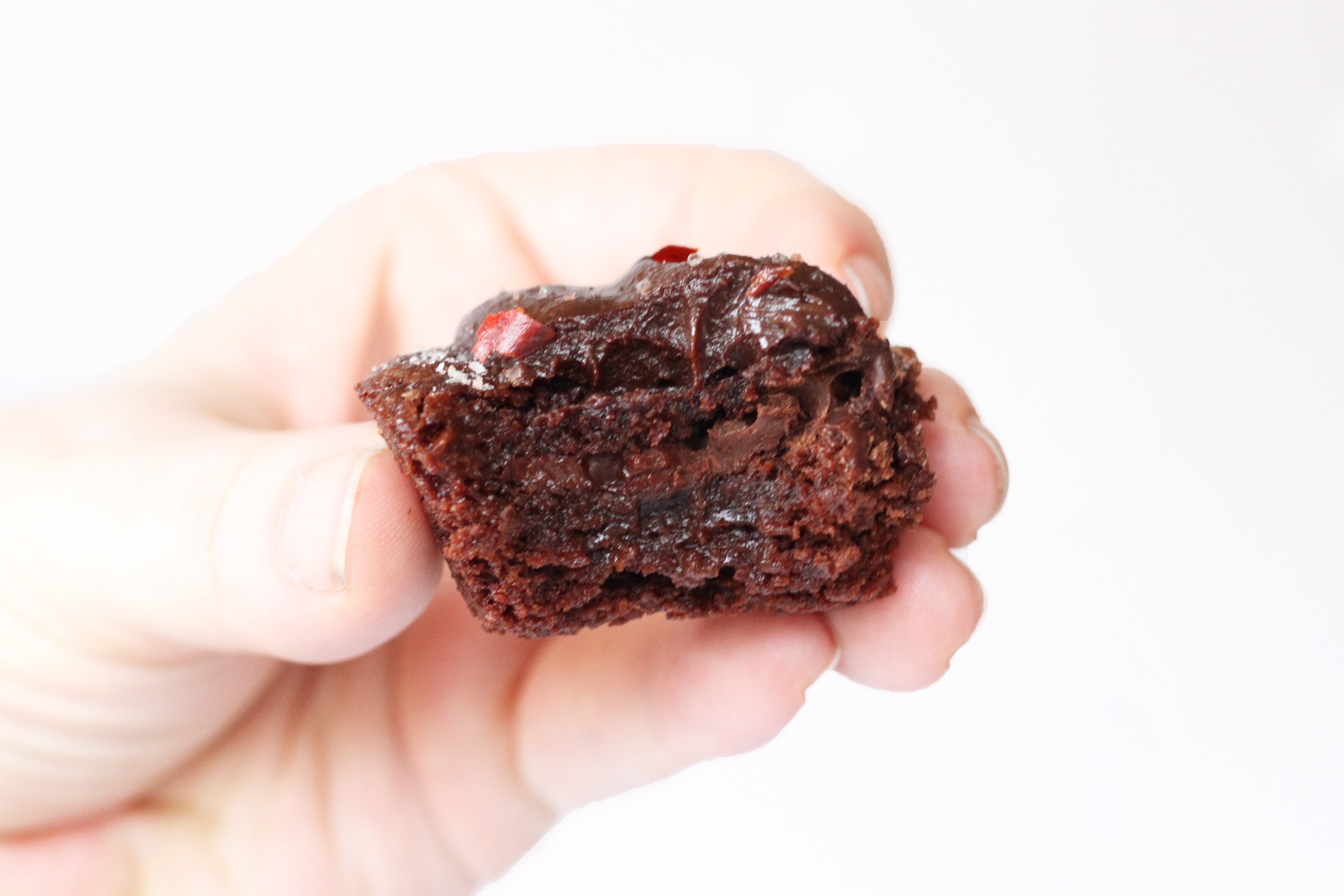 Close up side image of a bite taken out of a Miss Jones Baking Co Mexican Molten Chocolate Brownie Bite