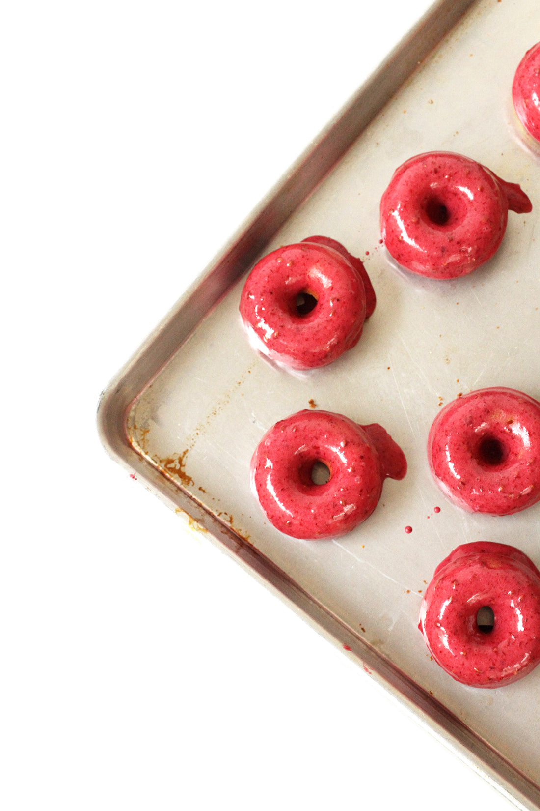 Image of five finished Miss Jones Baking Co Blackberry Buttermilk Donuts on baking sheet