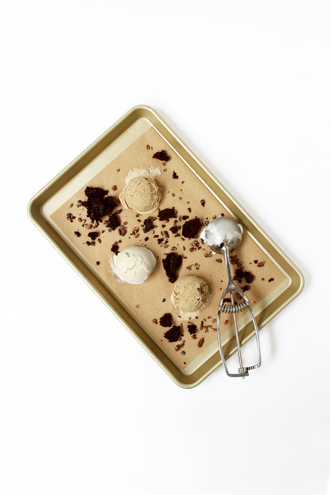 Image from above of a baking sheet with ice cream, brownie bits, cacao nibs and an ice cream scoop used for Miss Jones Baking Co Coffee Break Shake