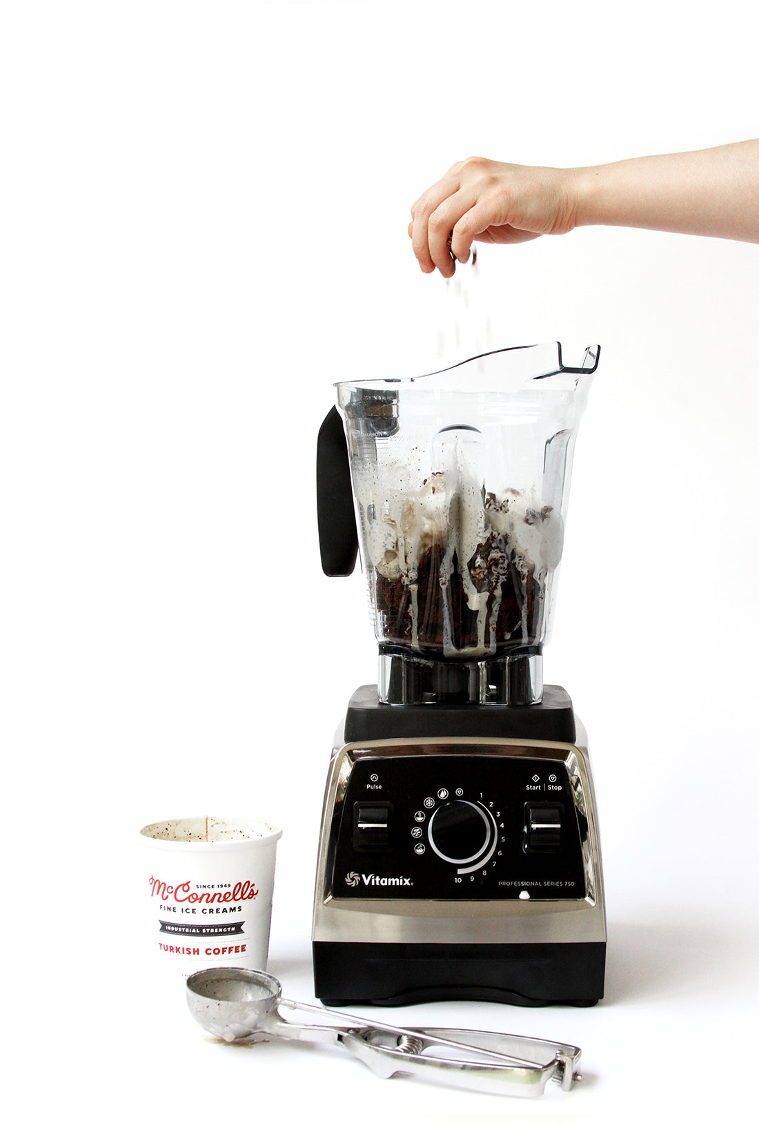 Image of a blender with ingredients for Miss Jones Baking Co Coffee Break Shake next to an ice cream scoop and a pint of McConnell's Fine Ice Cream
