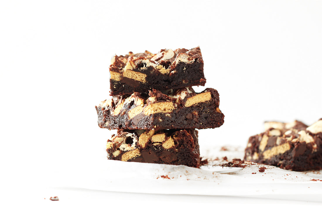 Image of three Miss Jones Baking Co Campfire Smores Brownies stacked next to a fourth