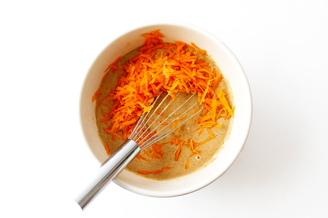 Image of shredded carrots being mixed into batter for Miss Jones Baking Co Carrot Spice Cake