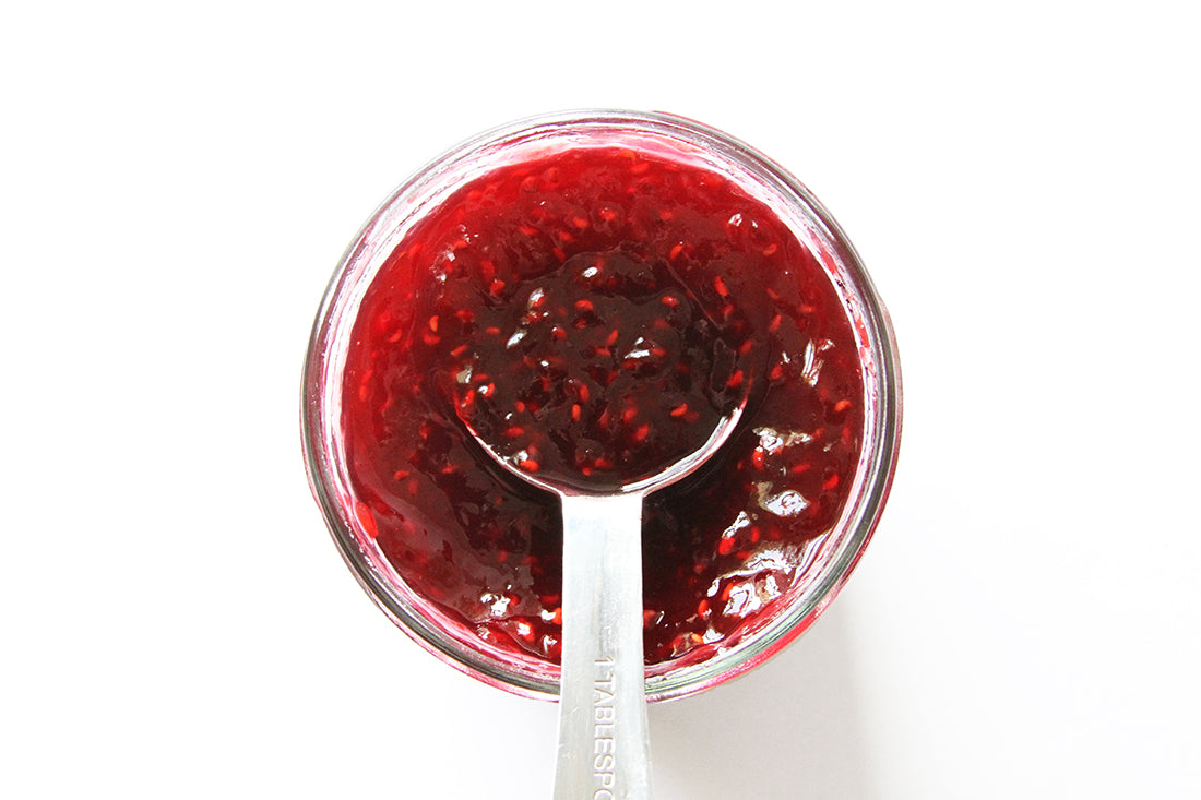 A tablespoon in a jar of jam used to top Miss Jones Baking Co Chocolate Cake Waffles