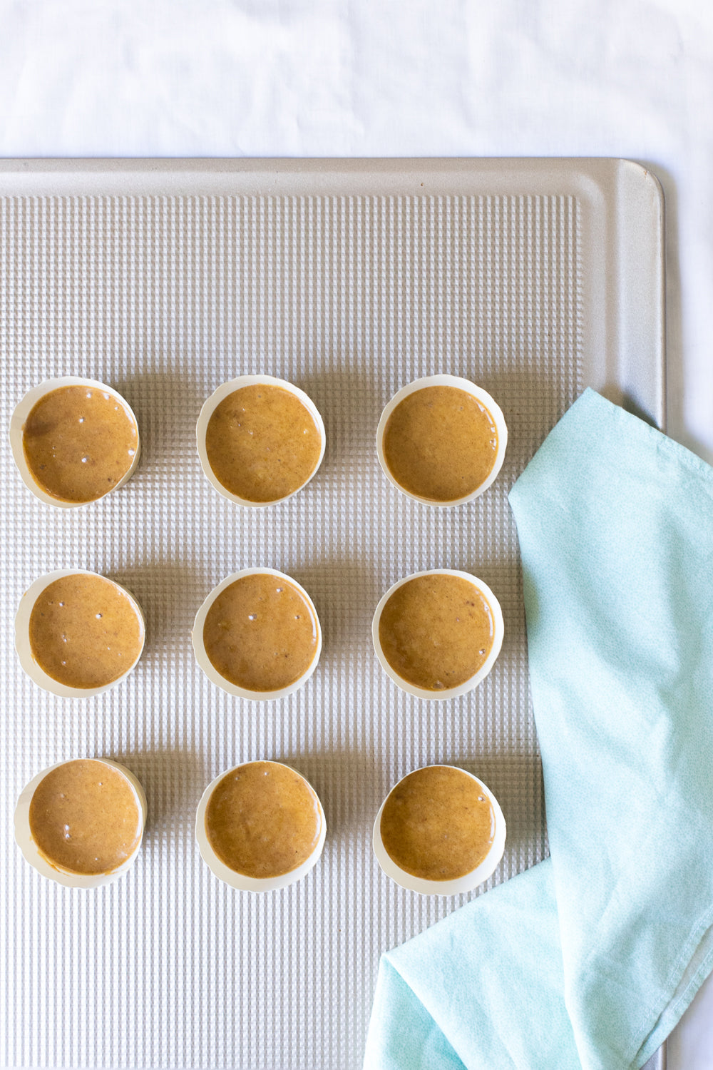 Image of nine Miss Jones Baking Co Festive Churro Cupcakes on a baking sheet