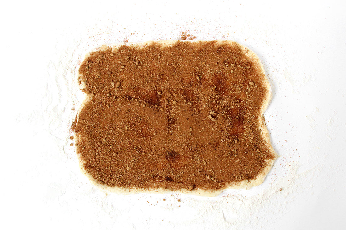 Image of dough for Miss Jones Baking Co Cake Mix Cinnamon Rolls spread out and topped with cinnamon sugar