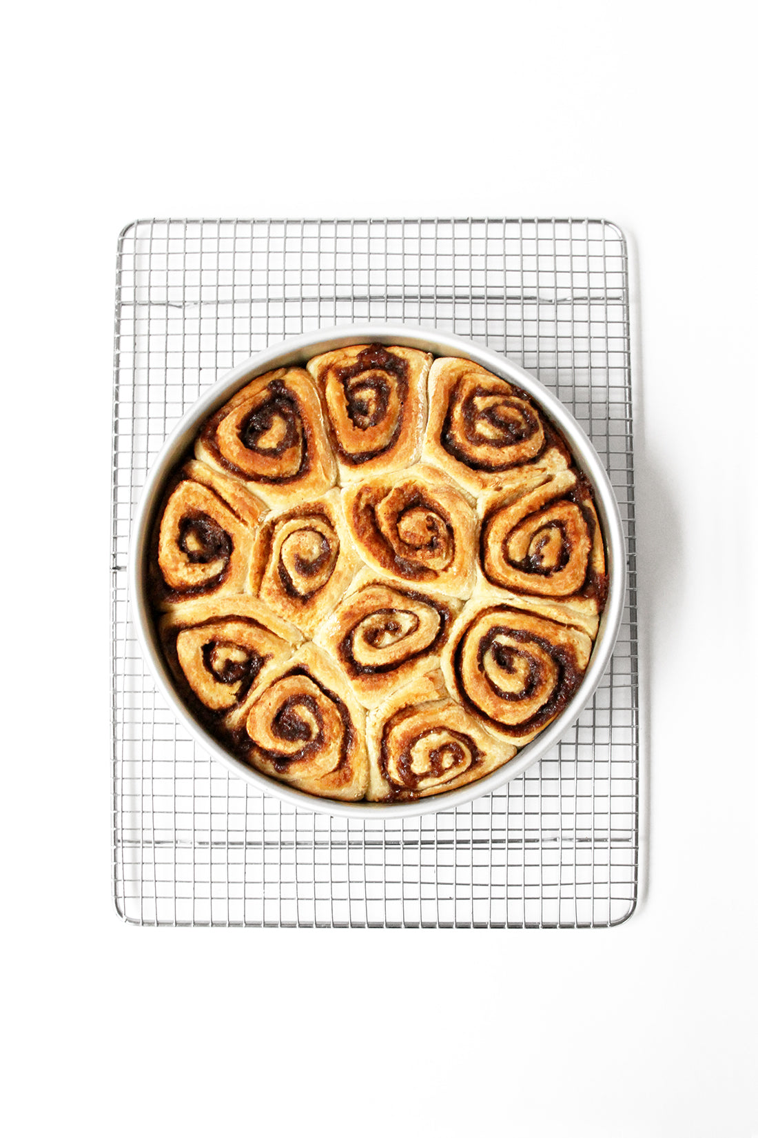 Image from above of a circular pan with twelve Miss Jones Baking Co Cake Mix Cinnamon Rolls