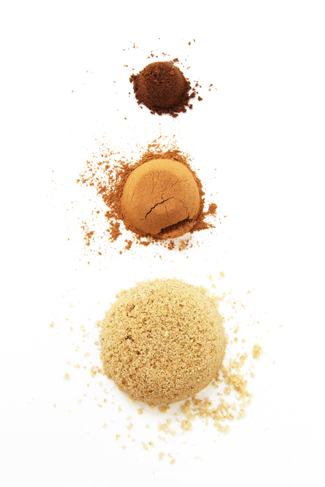 Image of three piles of nutmeg, cinnamon, and brown sugar in a vertical line used for Miss Jones Baking Co Cake Mix Cinnamon Rolls Recipe