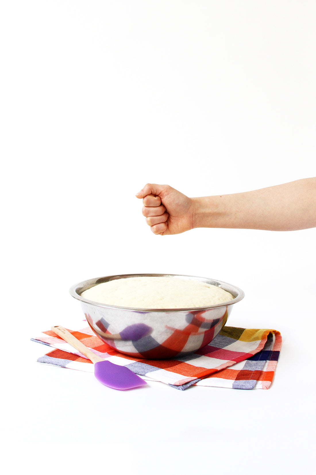 Image of dough in mixing bowl with hand above for Miss Jones Baking Co Cake Mix Cinnamon Rolls Recipe