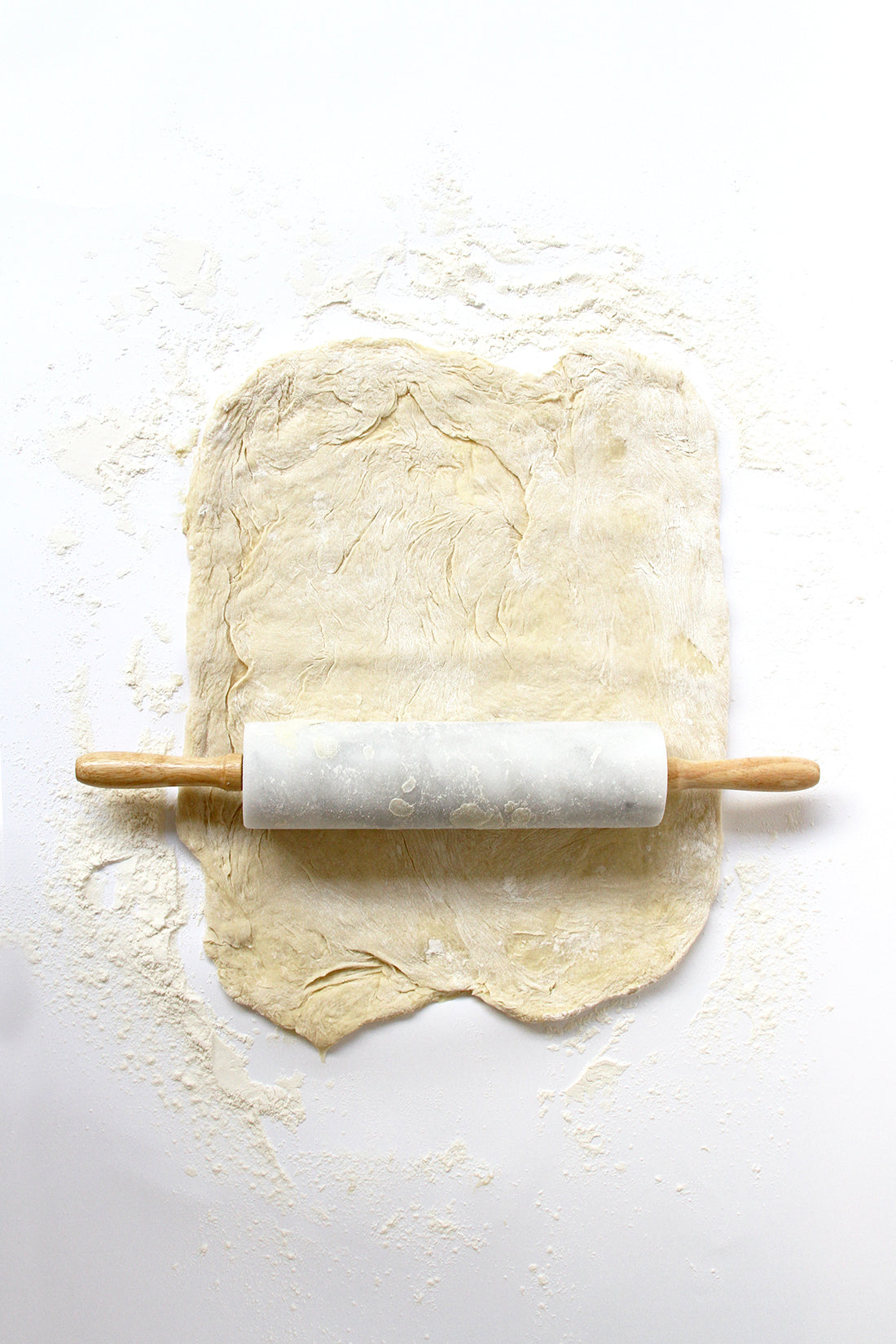 Image of dough for Miss Jones Baking Co Cake Mix Cinnamon Rolls Recipe being spread out with a rolling pin