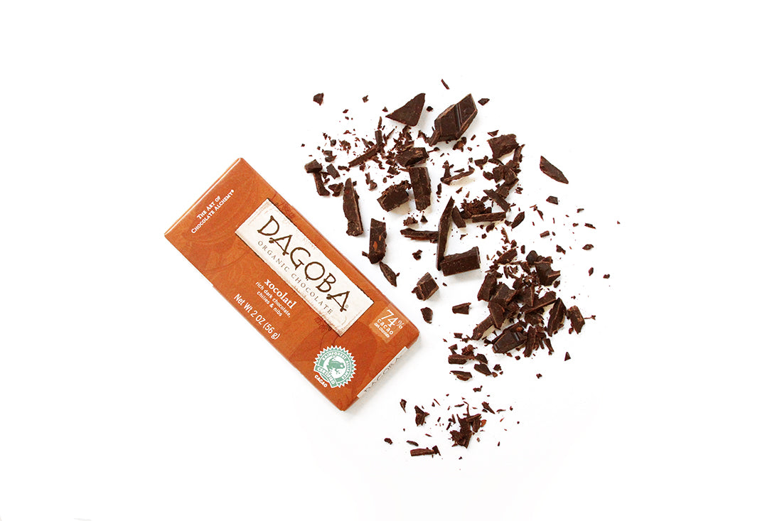 A bar of Dagoba xocolatl next to chopped up pieces of it for Miss Jones Baking Co Hot Cocoa Mug Cake