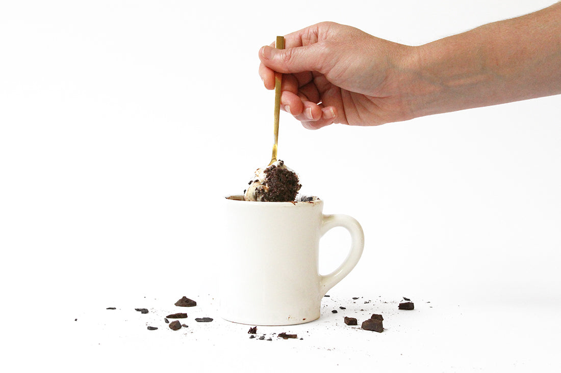 Image of the side of Miss Jones Baking Co Hot Cocoa Mug Cake with a fork taking a bite out of it