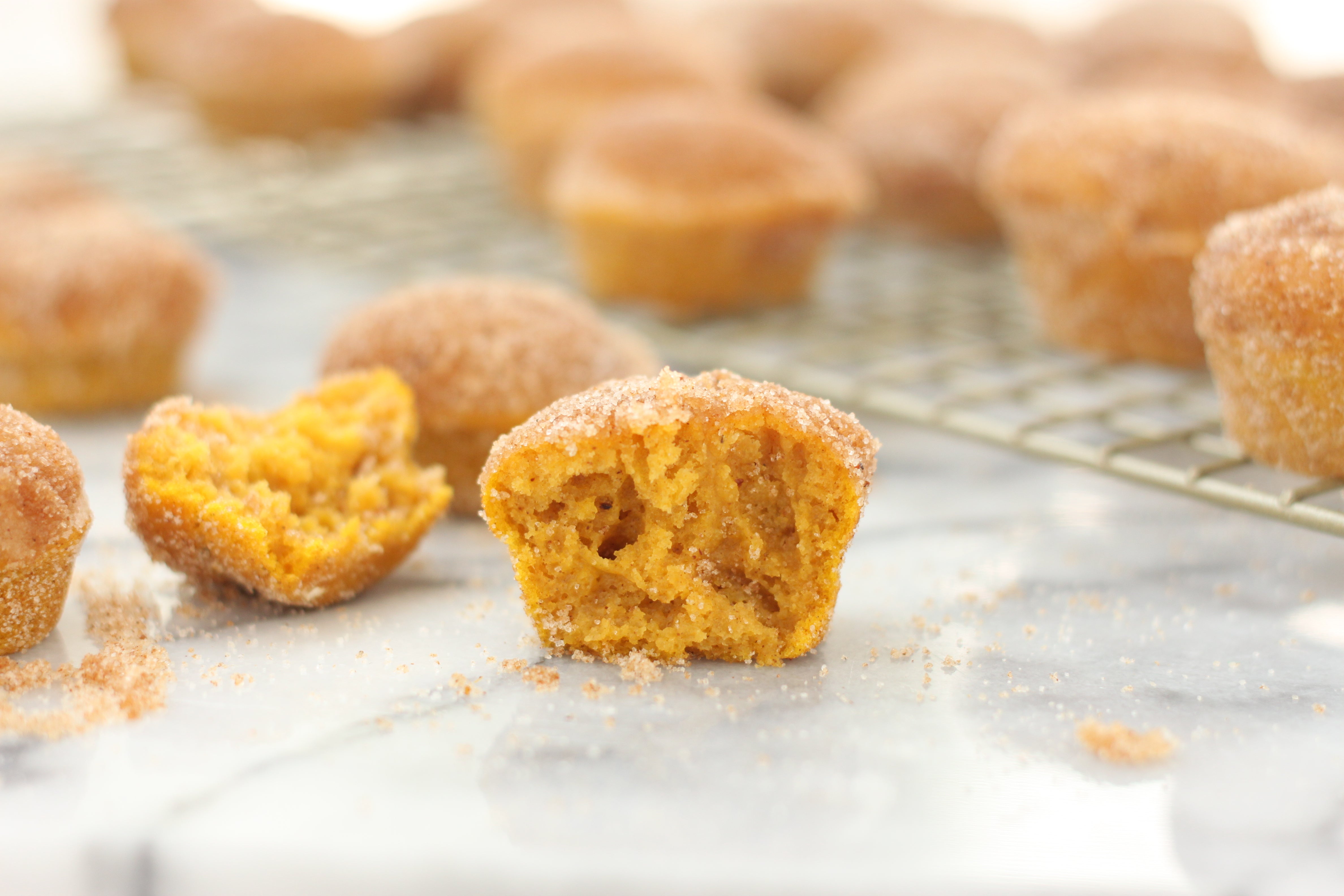 Image of Miss Jones Baking Co Mini Pumpkin Donut Muffins on a baking rack