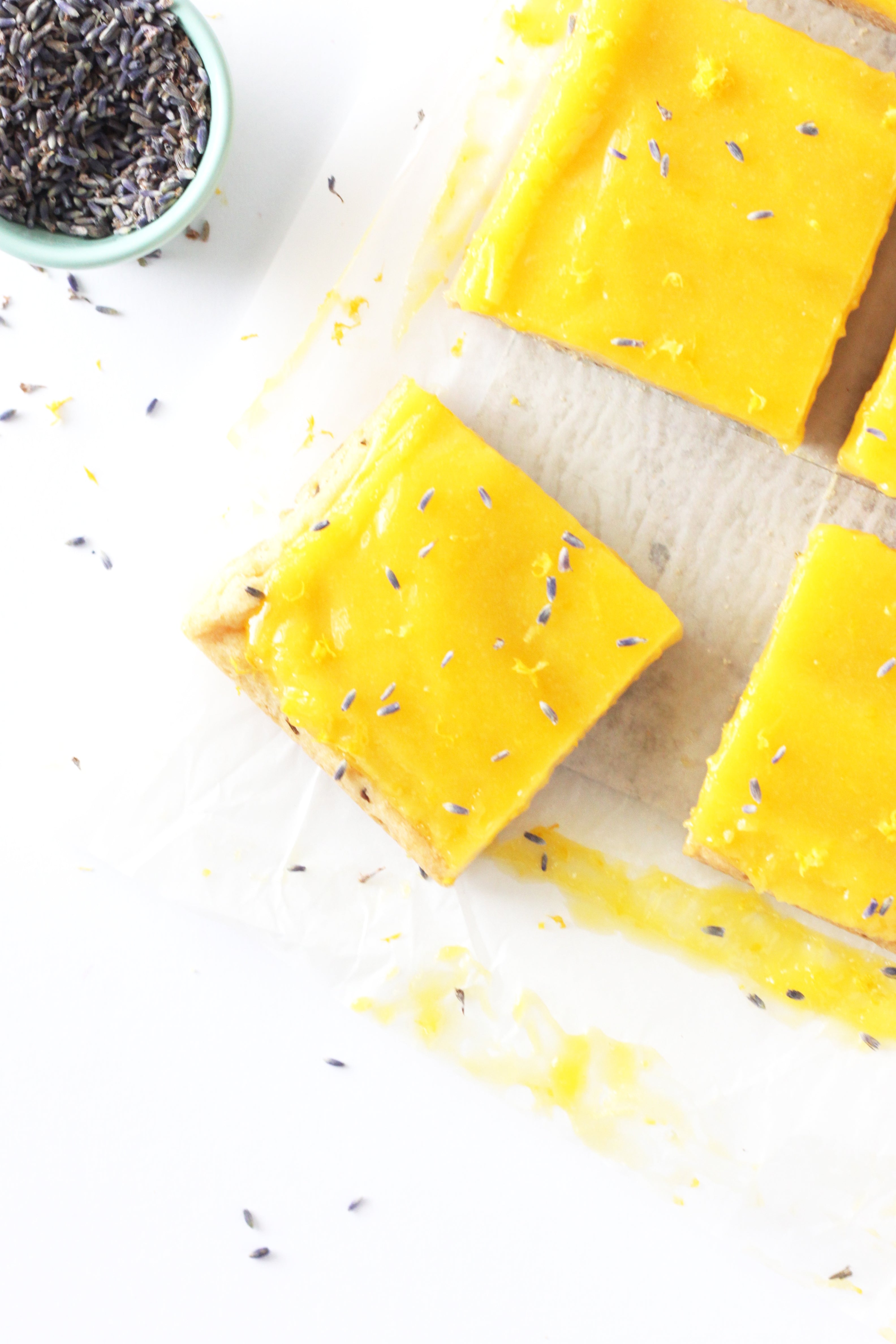 Image of Miss Jones Baking Co Lavender Lemon Bars next to a bowl of dried lavender