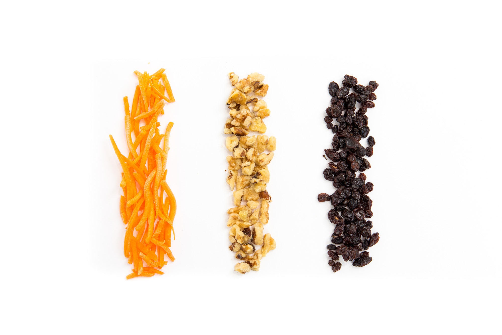 Image of three vertical line piles of carrots, walnuts, and raisins used in Miss Jones Baking Co Carrot Cake Bark