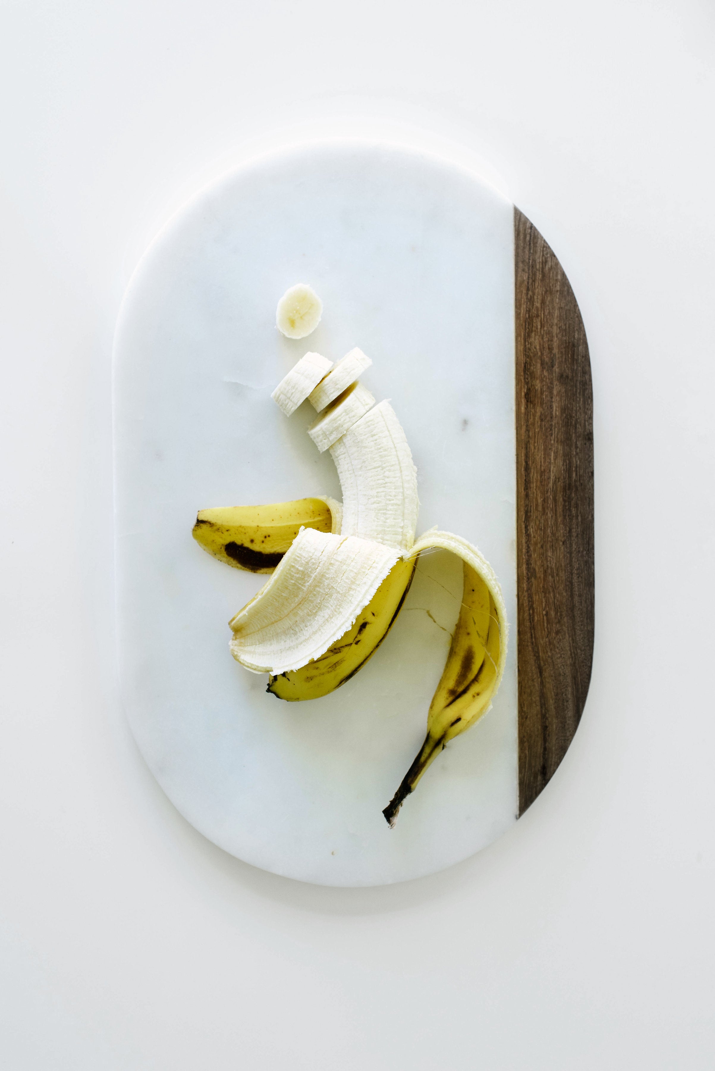 Image of a partly sliced banana used for Miss Jones Baking Co Chocolate Cake Batter Peanut Butter Nice Cream recipe